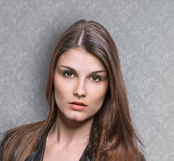 woman in a jacket on a gray background